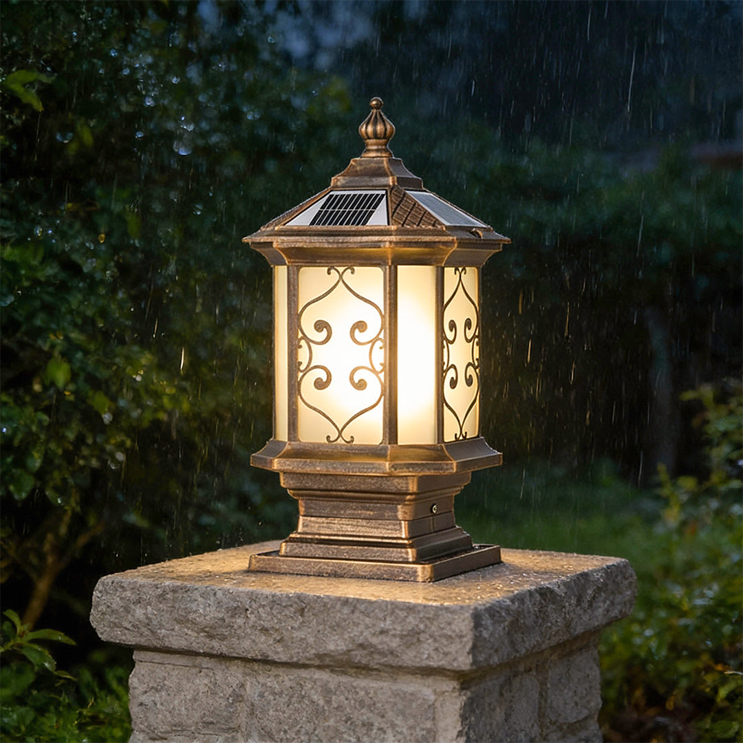 Outdoor gate pillar lights with intricate metalwork, providing warm illumination for a garden entrance.