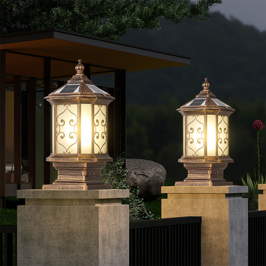 Outdoor gate pillar lights illuminating a stone pillar, creating a welcoming entrance at night.