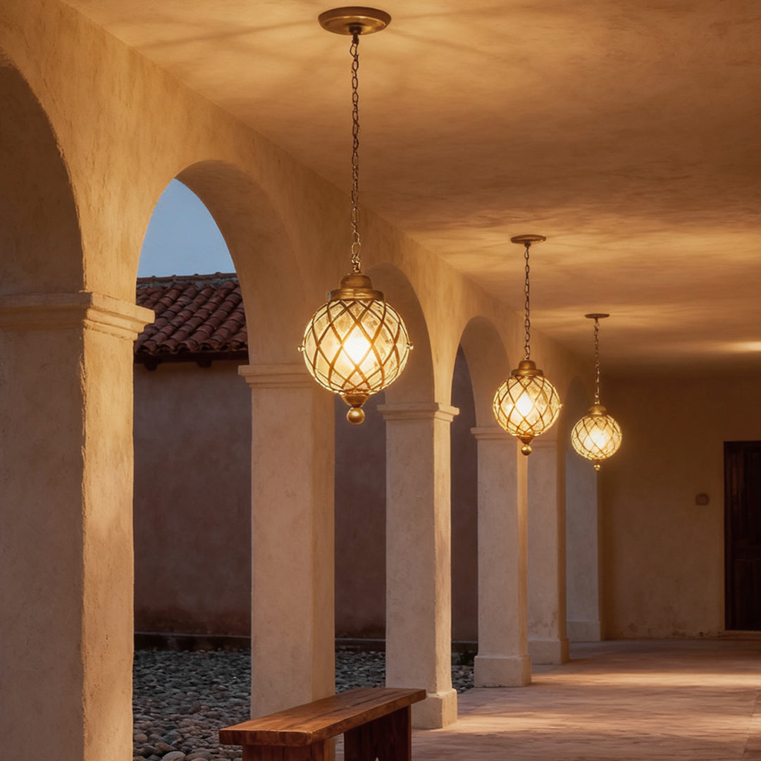 Outdoor globe pendant lights suspended along an arched corridor with warm ambient lighting.