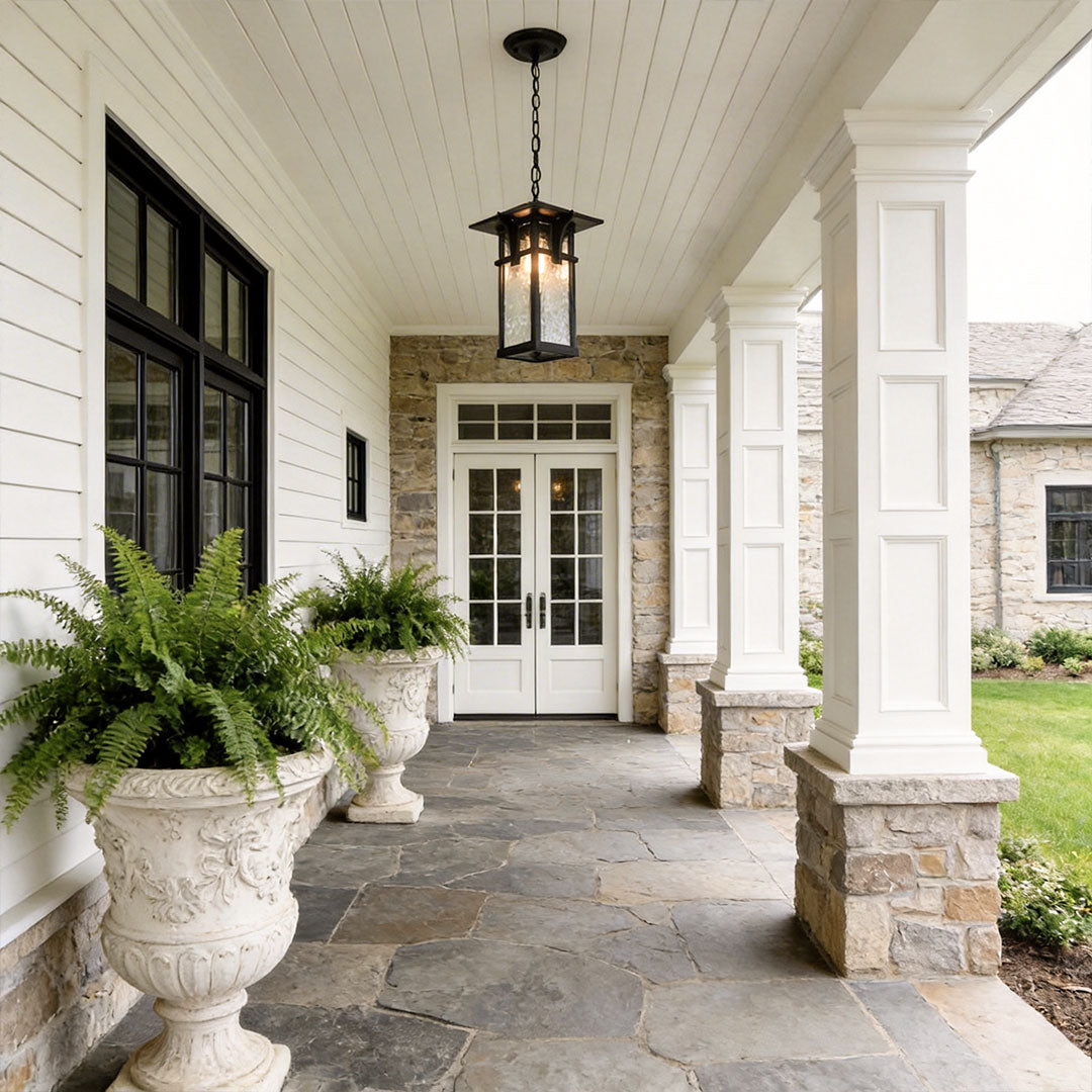 Outdoor hanging ceiling light fixtures with a vintage design, illuminating a white porch entrance.