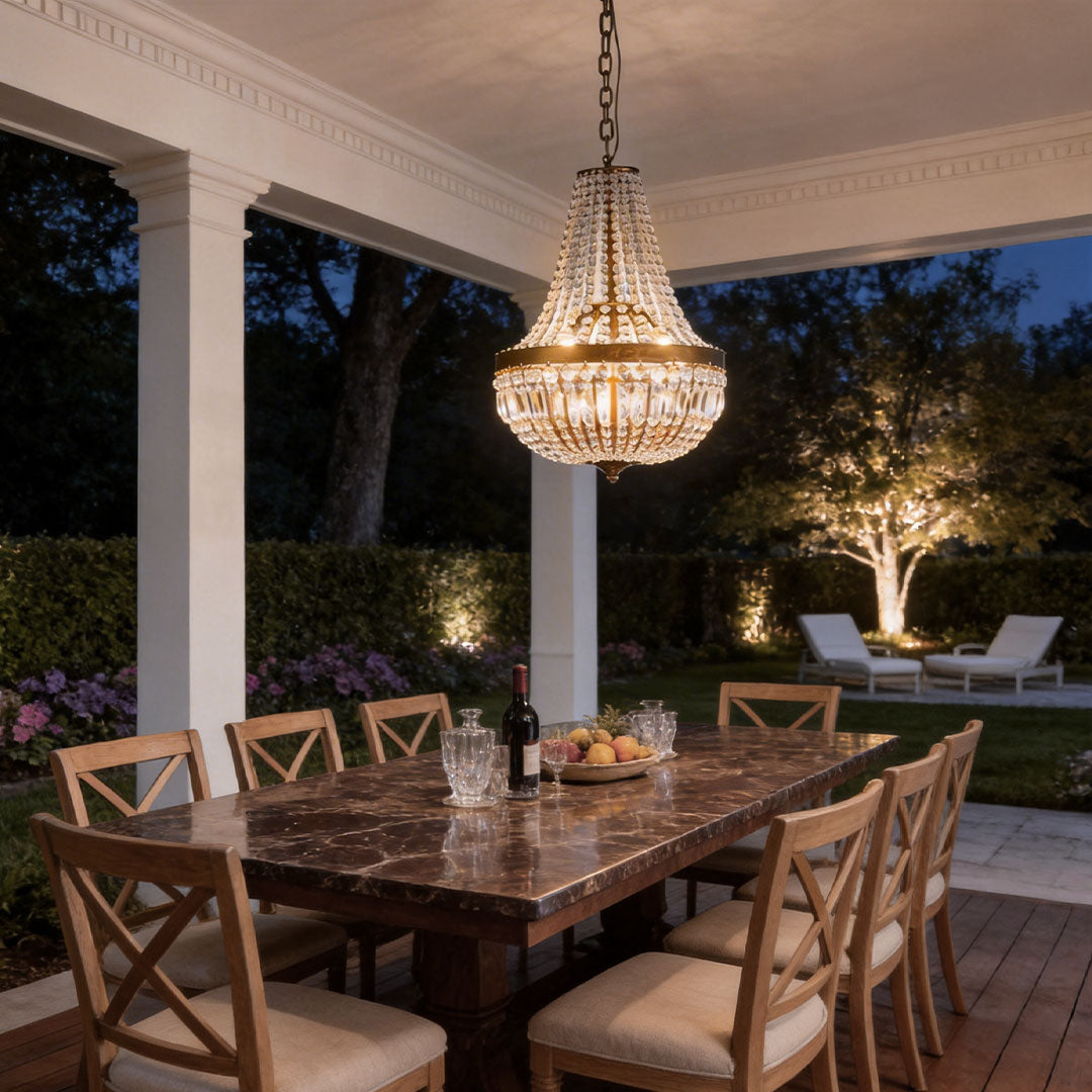 Outdoor hanging lantern light fixtures with a crystal design, illuminating a patio dining area.