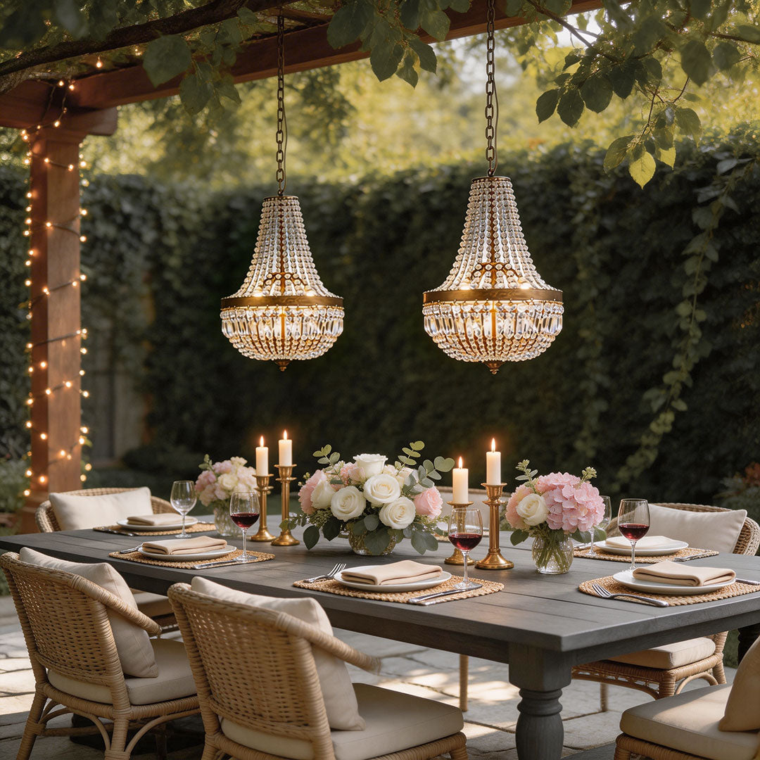 Outdoor hanging lantern light fixtures with a vintage design, illuminating a decorated dining table.