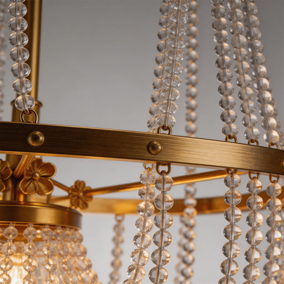 Close-up of outdoor hanging light fixture showcasing crystal and gold details.