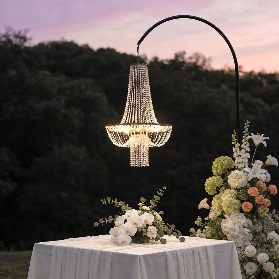 Outdoor hanging light fixture with crystal details, illuminating a garden dining table.