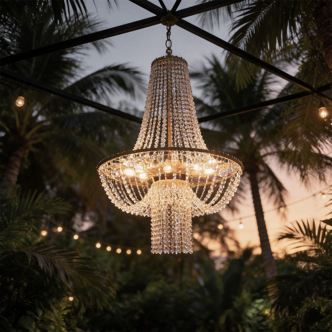 Outdoor hanging light fixture with crystal details, providing warm illumination for an outdoor event.