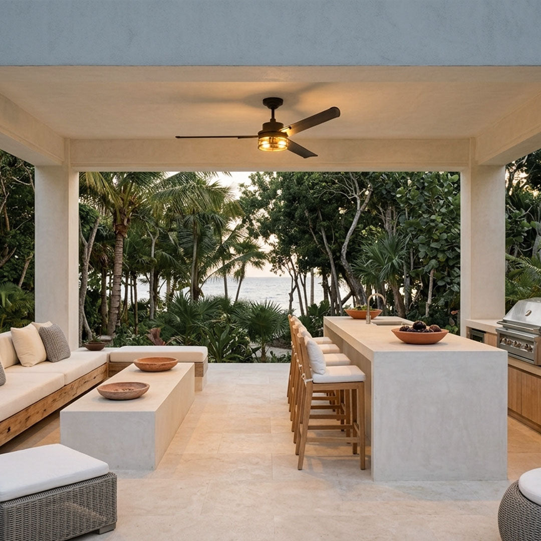 Black ceiling fan with lighting installed in a covered outdoor kitchen and lounge area.