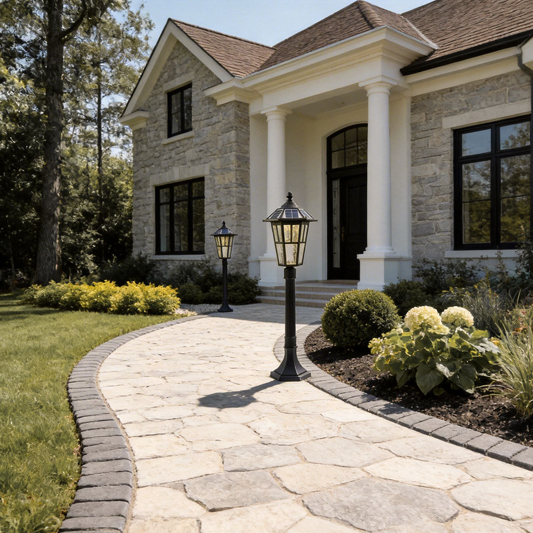 Outdoor landscape path lighting with a modern design, lighting up a stone pathway.