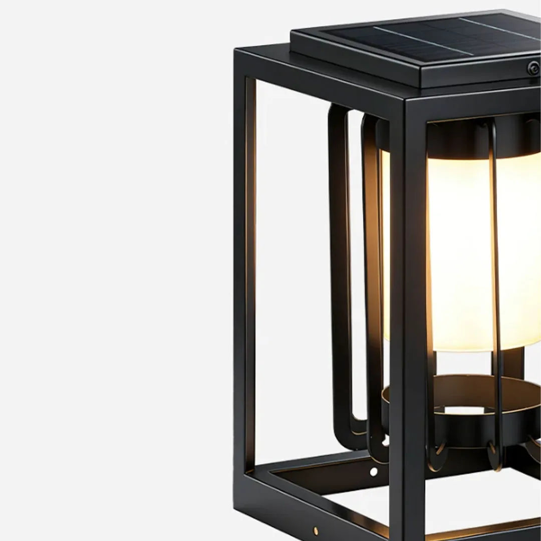Close-up of an outdoor lantern light fixture with a black rectangular frame and frosted inner diffuser.
