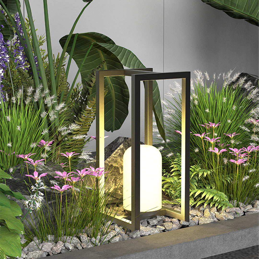 Outdoor lanterns black placed in a garden landscape, providing warm pathway lighting among plants.