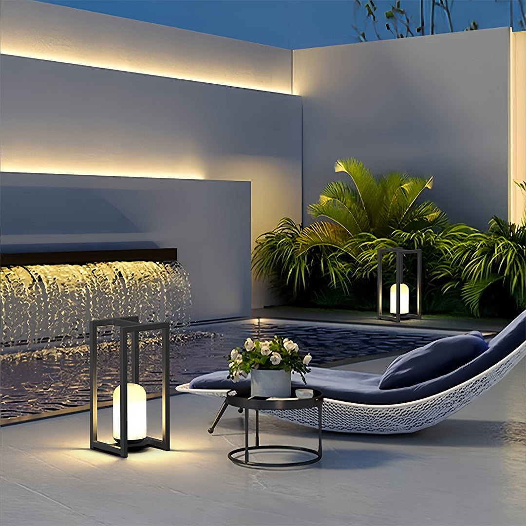 Modern outdoor lanterns black lighting used beside a poolside lounge for stylish outdoor ambiance.