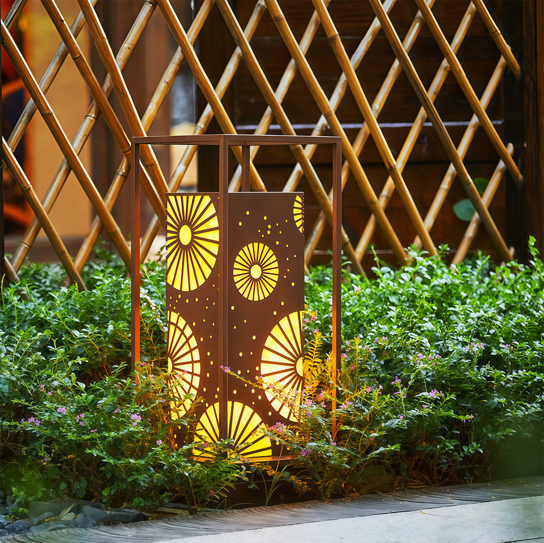 Outdoor LED bollard light with a contemporary design, adding warmth and charm to a landscaped garden.