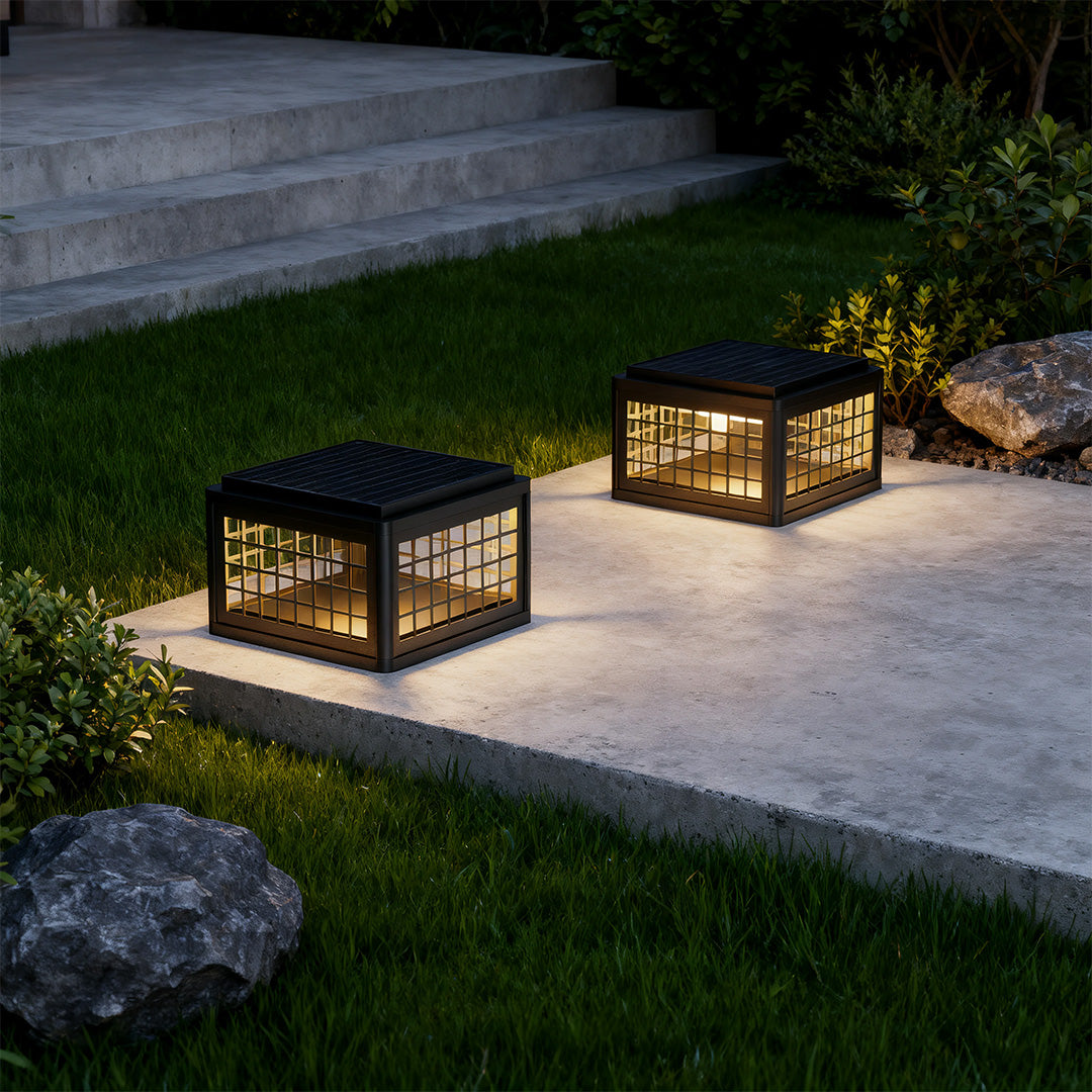 Outdoor LED pillar light in a garden with plants, adding a contemporary touch to the outdoor space.