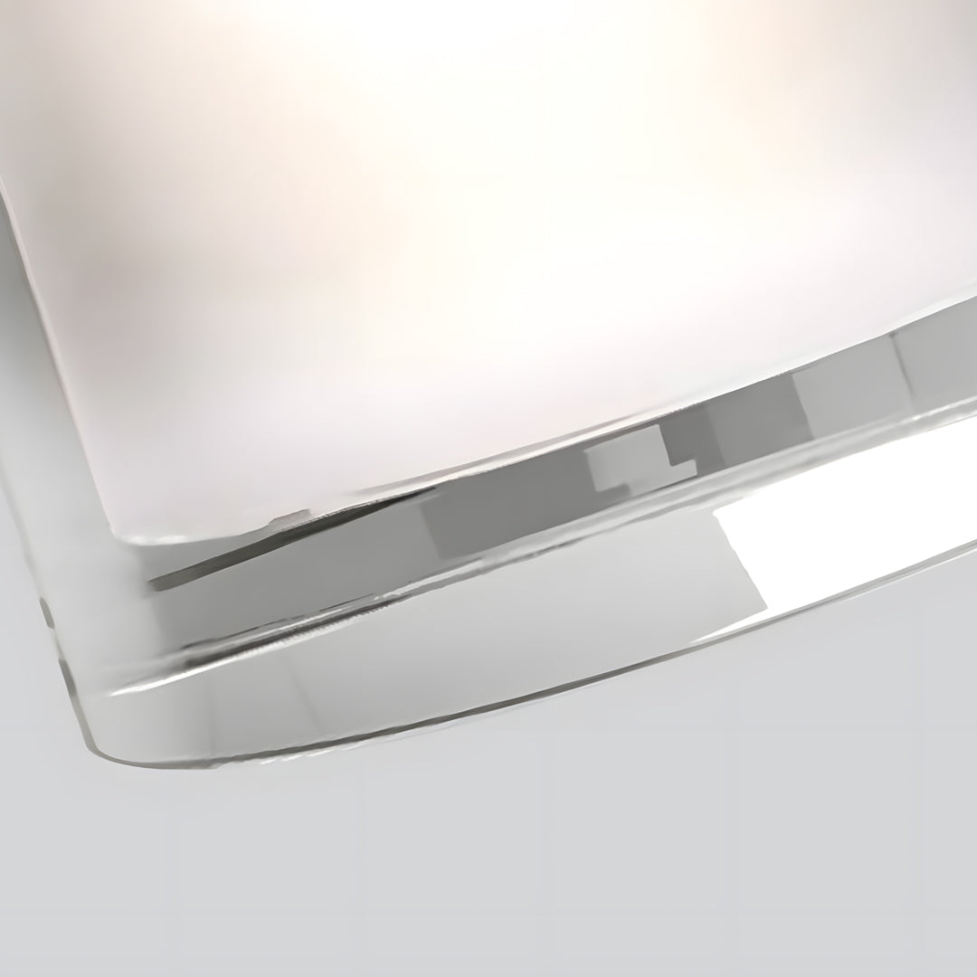 Close-up detail of sleek outdoor light fixtures wall with curved metal housing and diffused glow.
