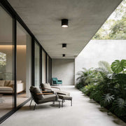 Outdoor lighting downlights illuminating a modern corridor with warm directional glow.