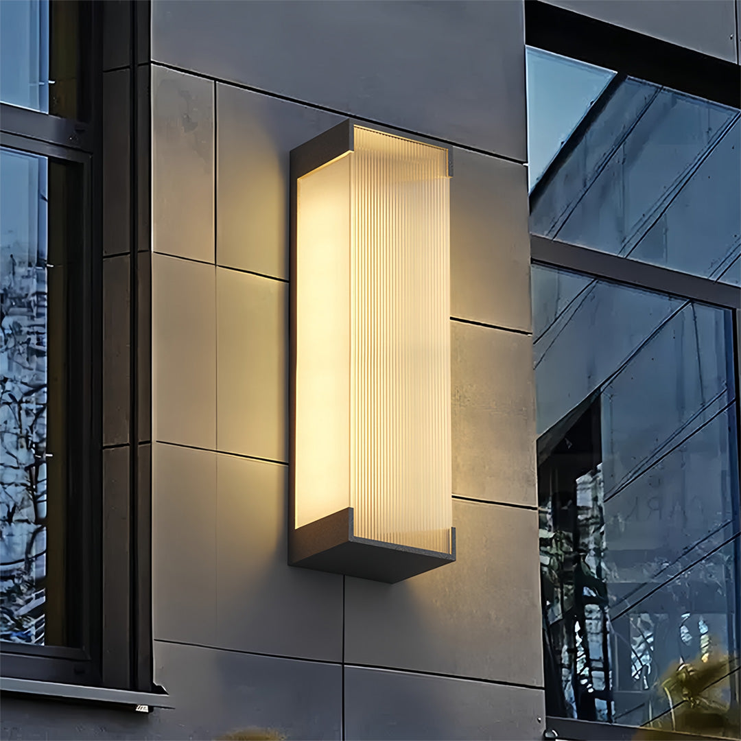 Stylish gold outdoor lighting fixtures wall mounted on a contemporary exterior façade with soft evening illumination.