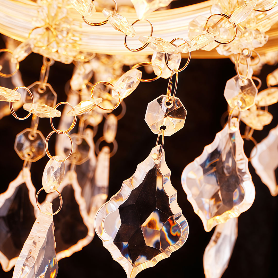 Close-up of outdoor lighting hanging showcasing crystal and gold details.