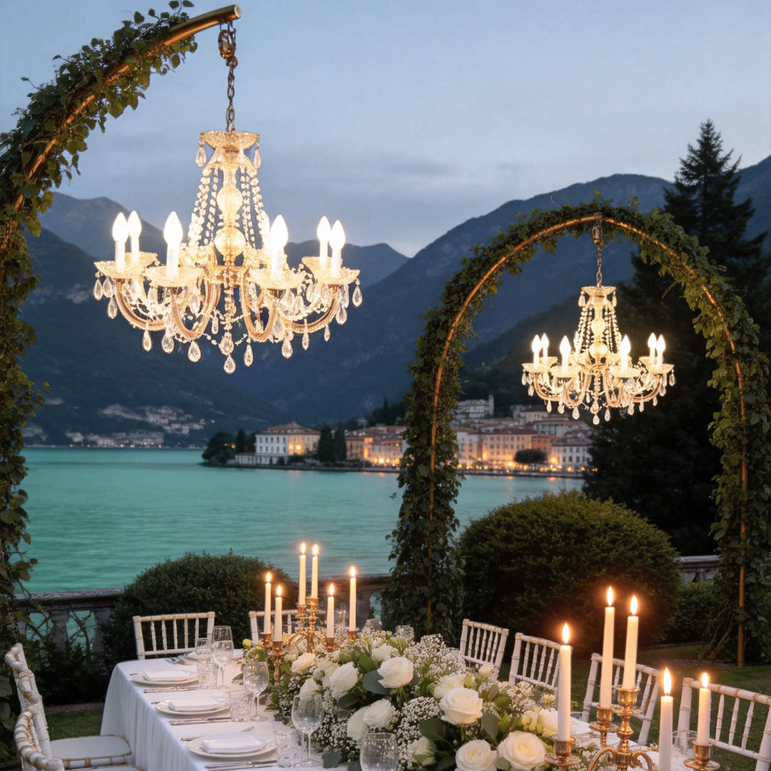 Outdoor lighting hanging with crystal details, providing warm illumination for a lakeside event.