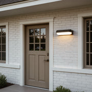 Outdoor lighting wall with a contemporary design, providing warm illumination near a patio.