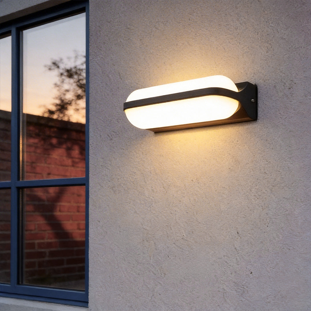 Outdoor lighting wall with a modern rectangular design, illuminating a house exterior at dusk.