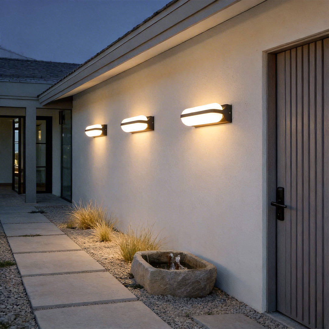 Outdoor lighting wall with a modern design, mounted on a white brick house.