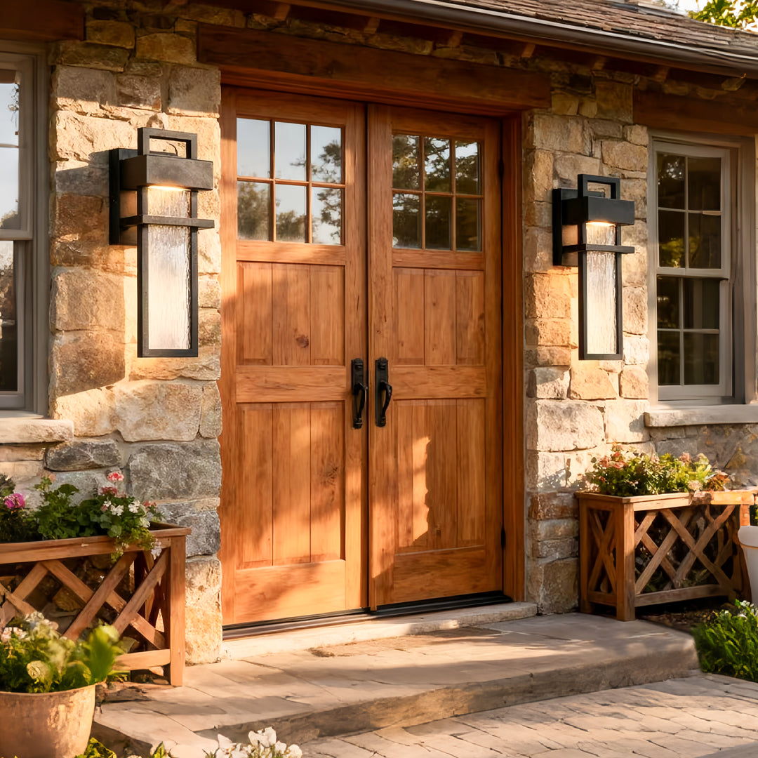 rustic home exterior highlighted by black outdoor lighting wall mount on stone wall