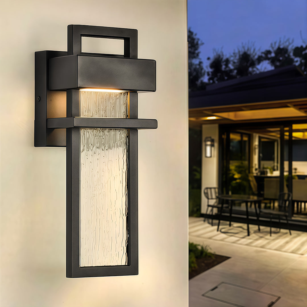 sleek black outdoor lighting wall mount installed beside patio door with warm illumination