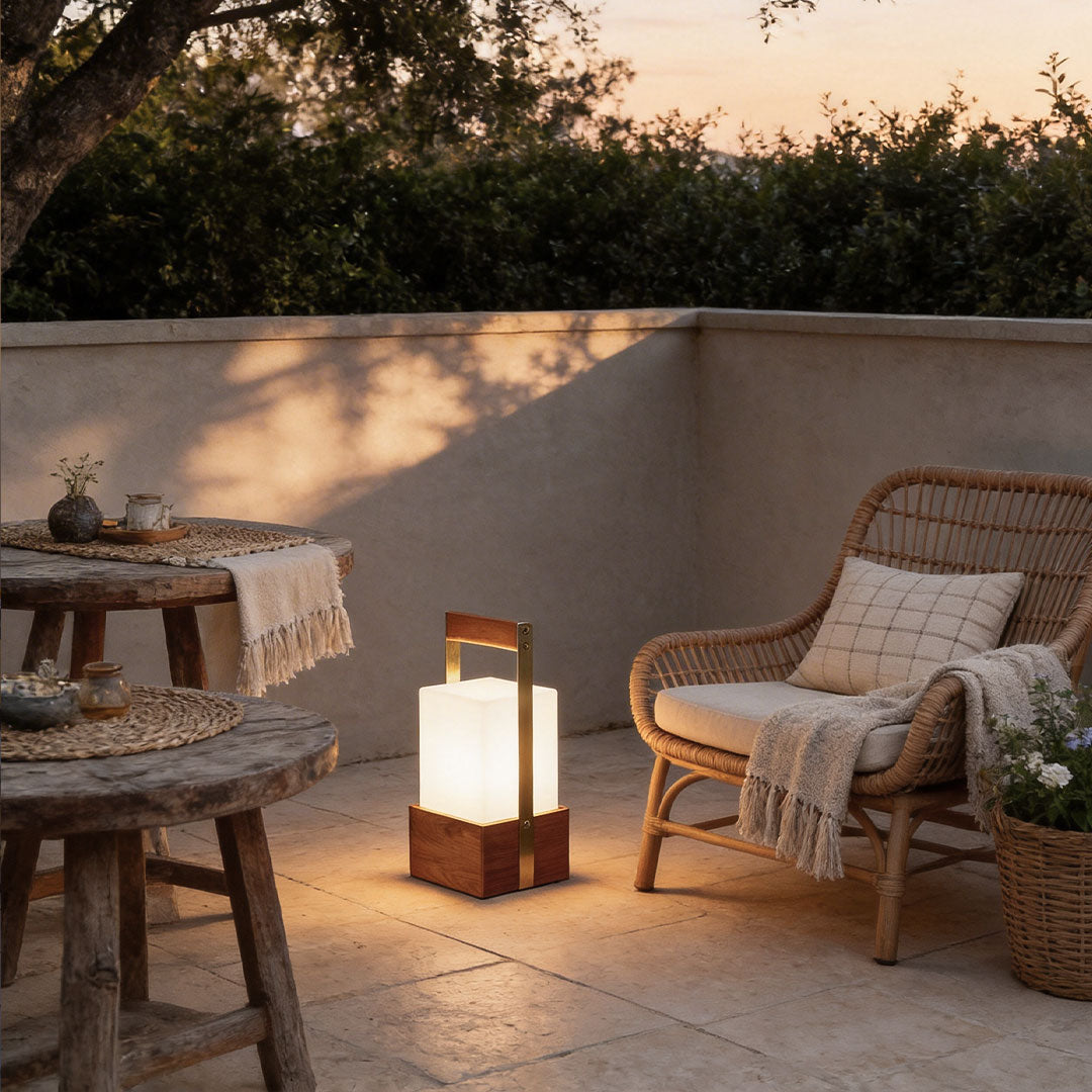 Outdoor lights lanterns with a sleek design, illuminating a cozy outdoor seating area.