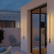 Modern outdoor lights wall sconces framing a patio door and creating a warm inviting atmosphere.