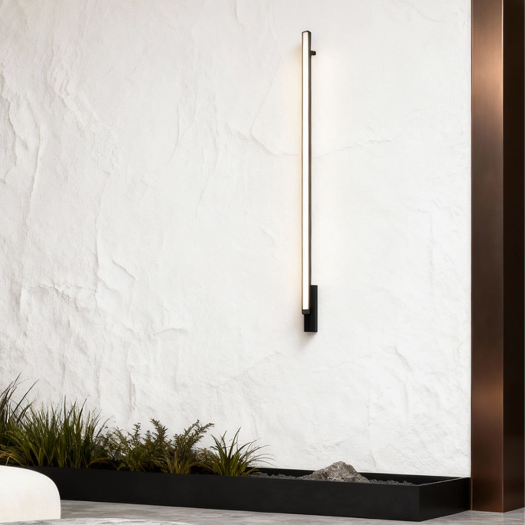 Sleek vertical outdoor lights wall sconces installed on a textured white exterior wall for modern accent lighting.