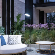 Outdoor modern floor lamps illuminating a garden seating area with bright directional LED light.