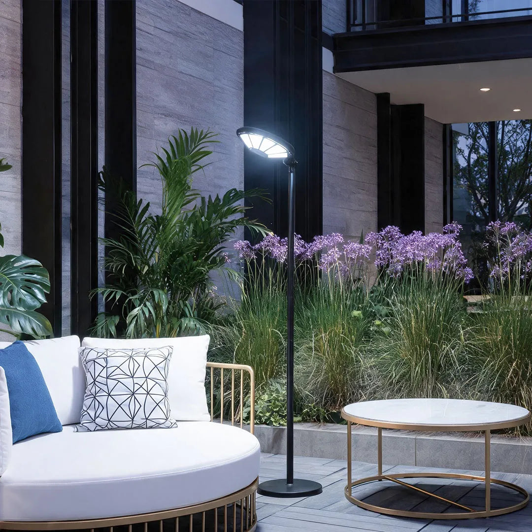 Outdoor modern floor lamps illuminating a garden seating area with bright directional LED light.
