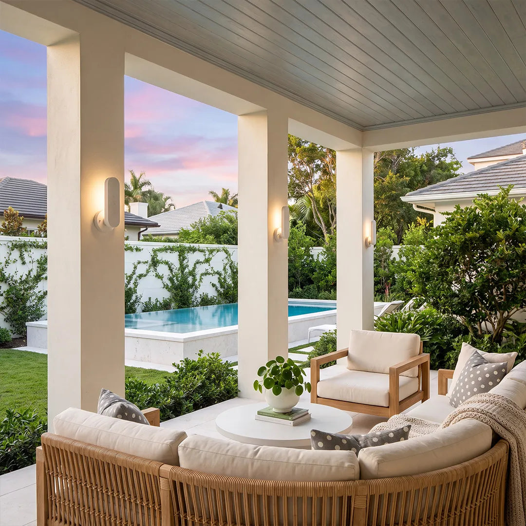 Outdoor modern wall lighting installed on a covered patio overlooking a pool and garden.