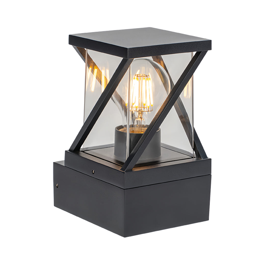Black framed outdoor modern wall sconce featuring a cross-brace lantern design with warm glowing bulb.