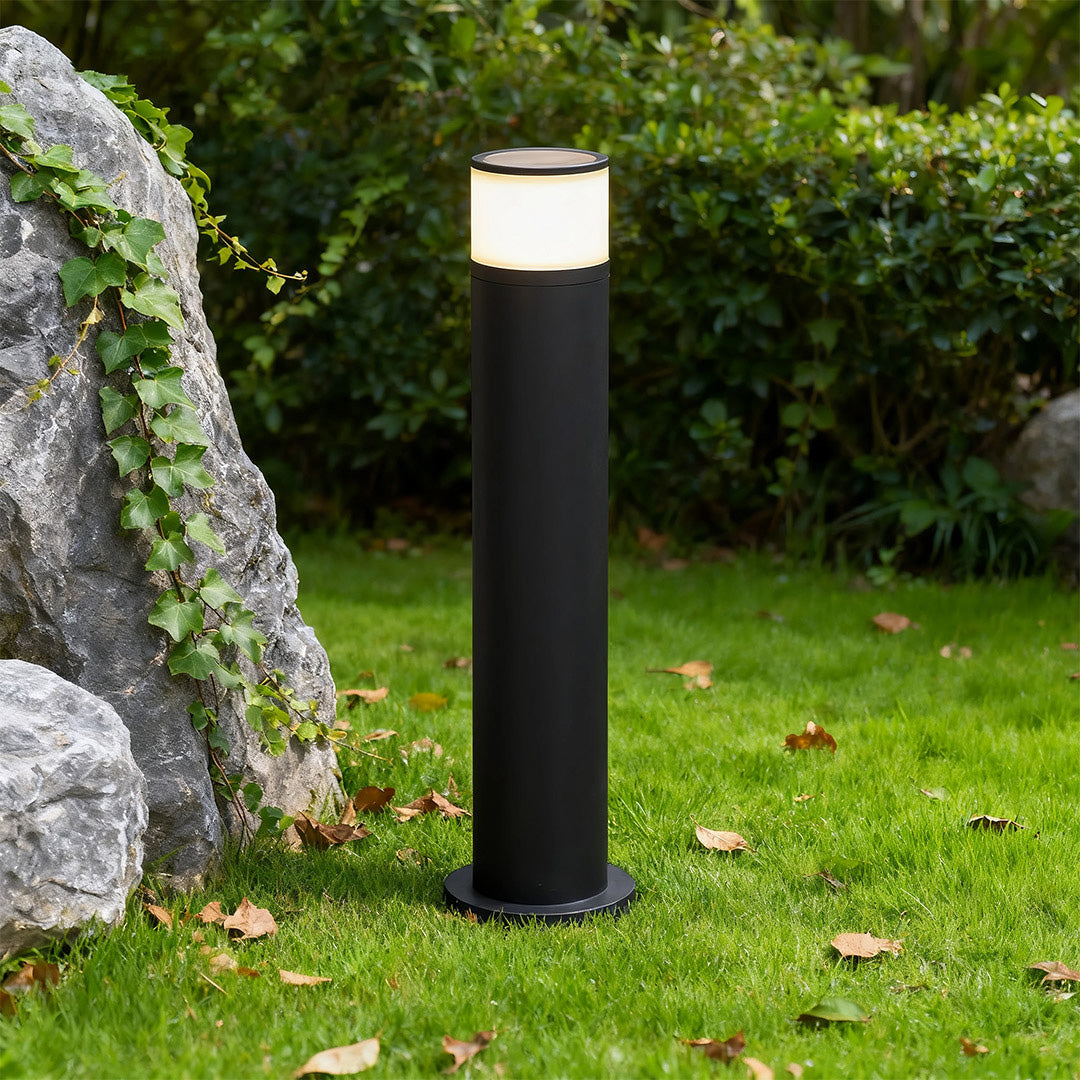 Outdoor path light installed along a garden pathway, providing warm and inviting illumination.