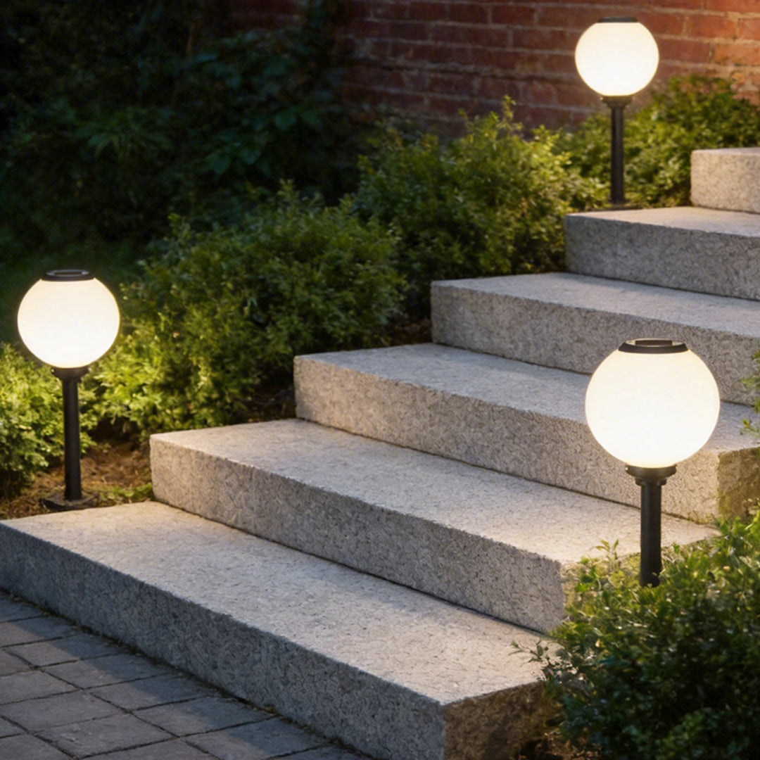 Outdoor path light globe enhancing a contemporary garden pathway with elegant ambient light.