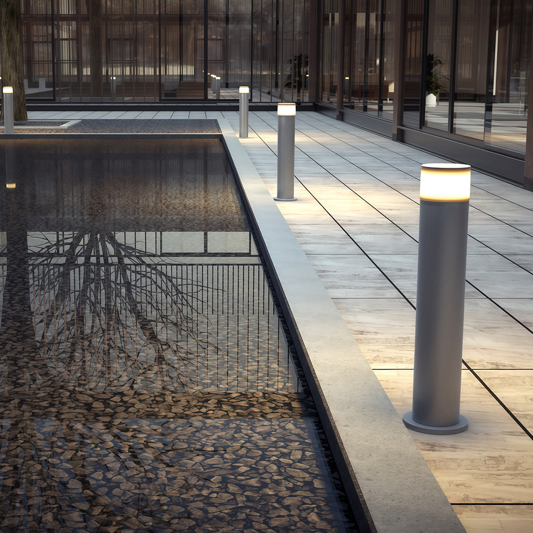 Outdoor path light placed near a grassy area, enhancing the outdoor ambiance with subtle lighting.