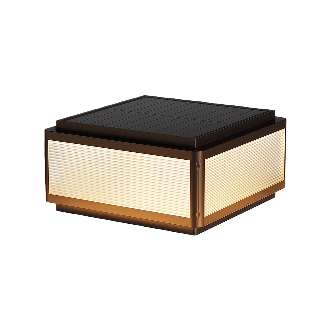 Outdoor patio pillar light featuring a minimalist square design with a textured top and warm light.