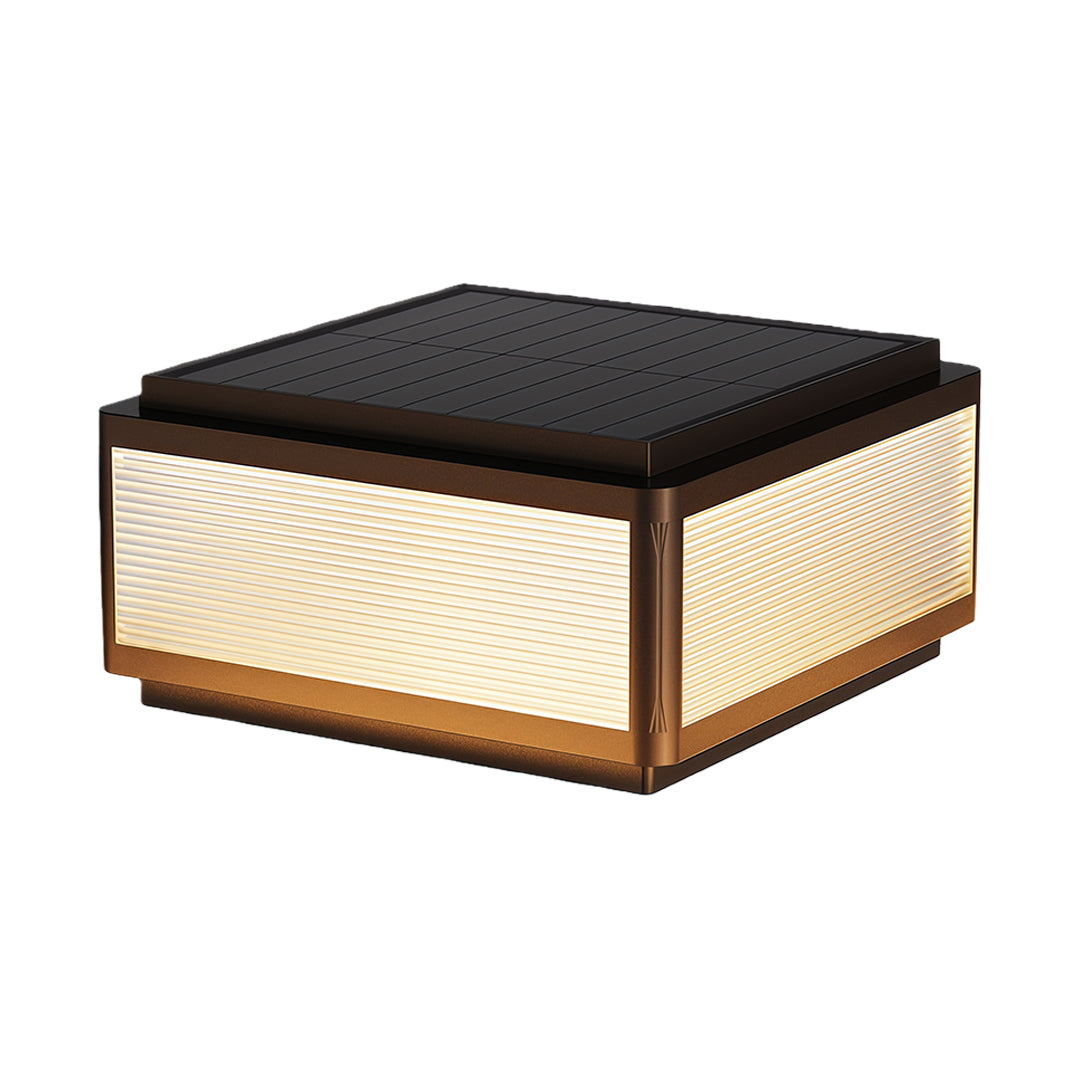 Outdoor patio pillar light installed near a railing by a pond, providing warm and inviting illumination.