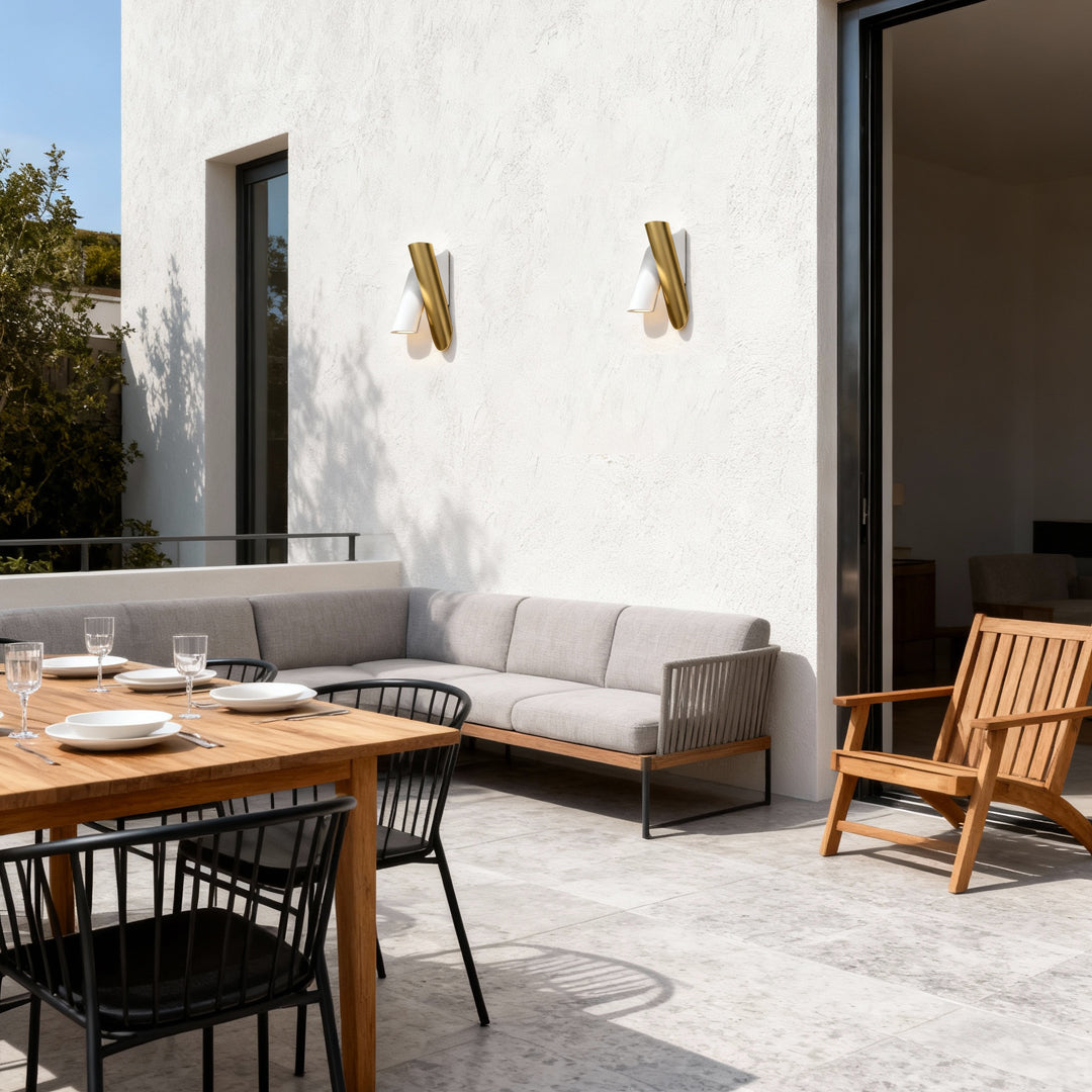 Up and down wall lights outdoor installed on a bright patio wall illuminating outdoor seating.