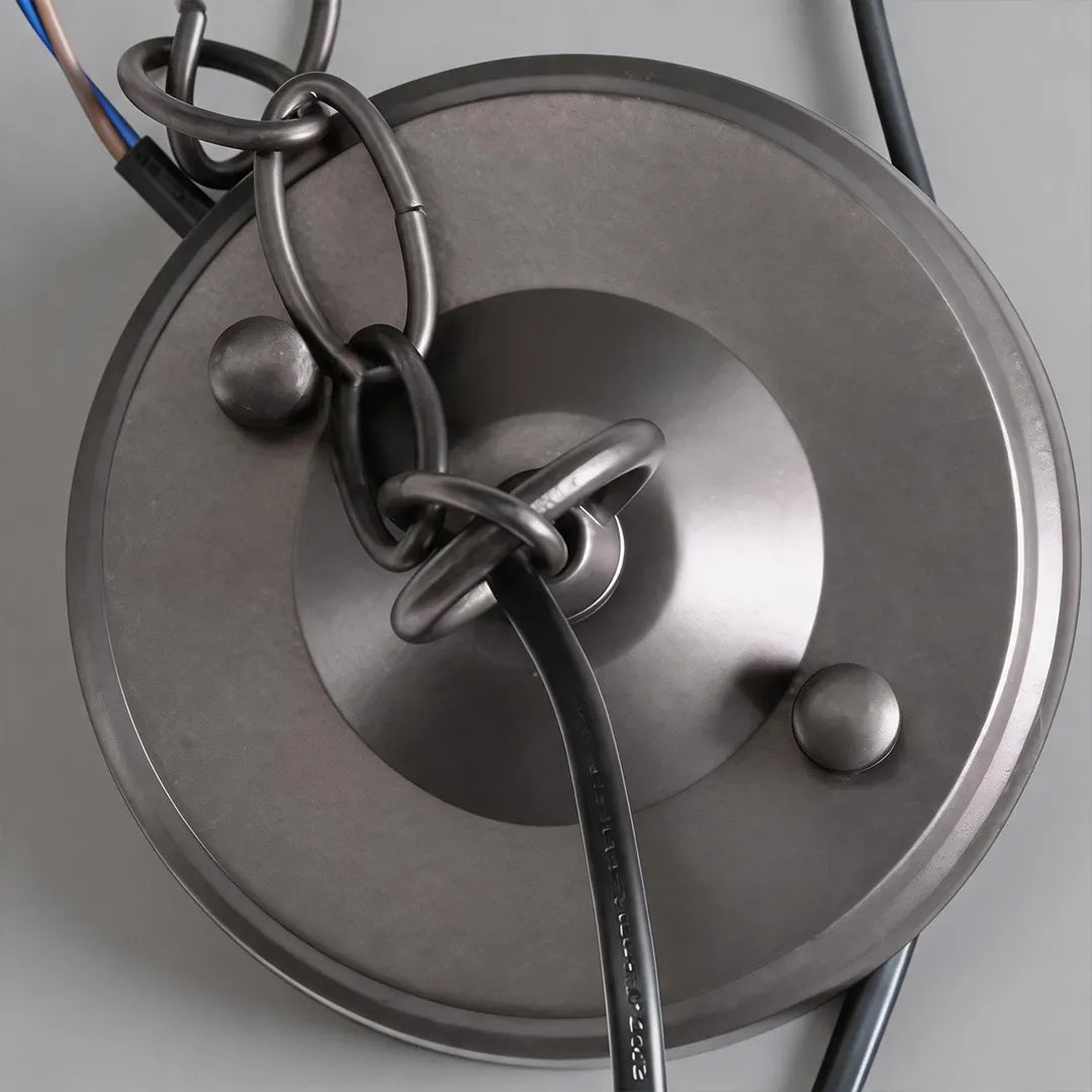 Close-up of the canopy, chain, and hanging hardware on outdoor pendant lighting fixtures.