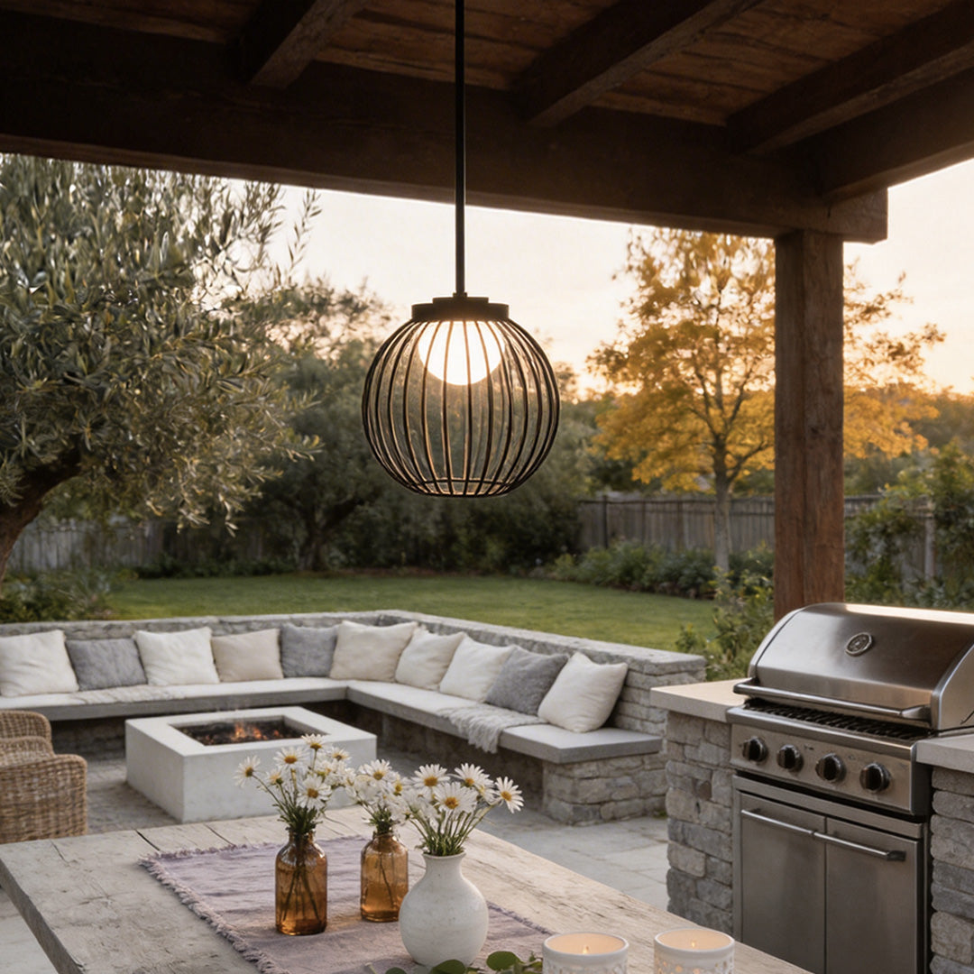 Outdoor pendant lighting modern with a black metal cage design, hanging above a patio seating area.