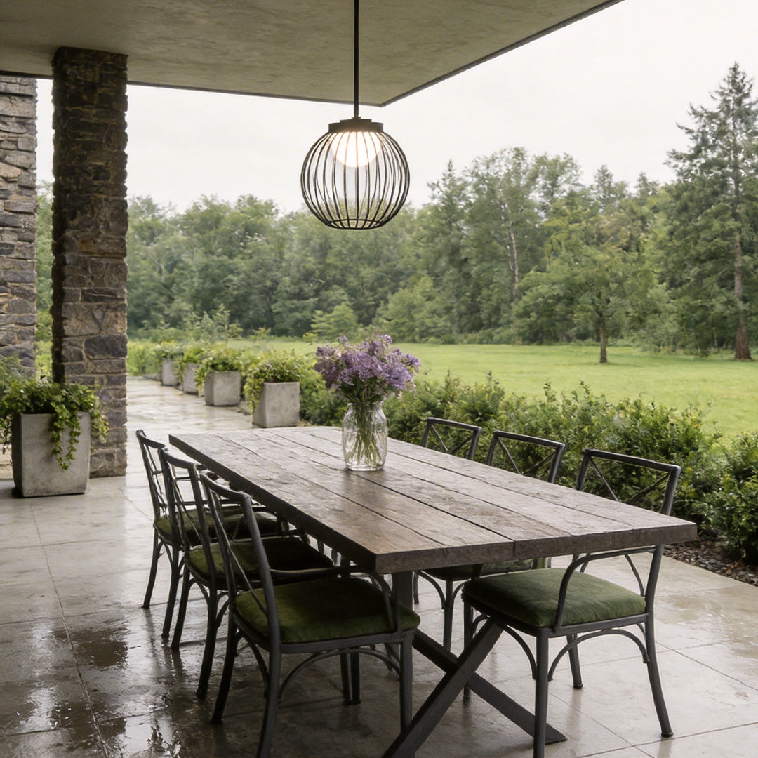 Outdoor pendant lighting modern with a black metal cage design, providing warm illumination.