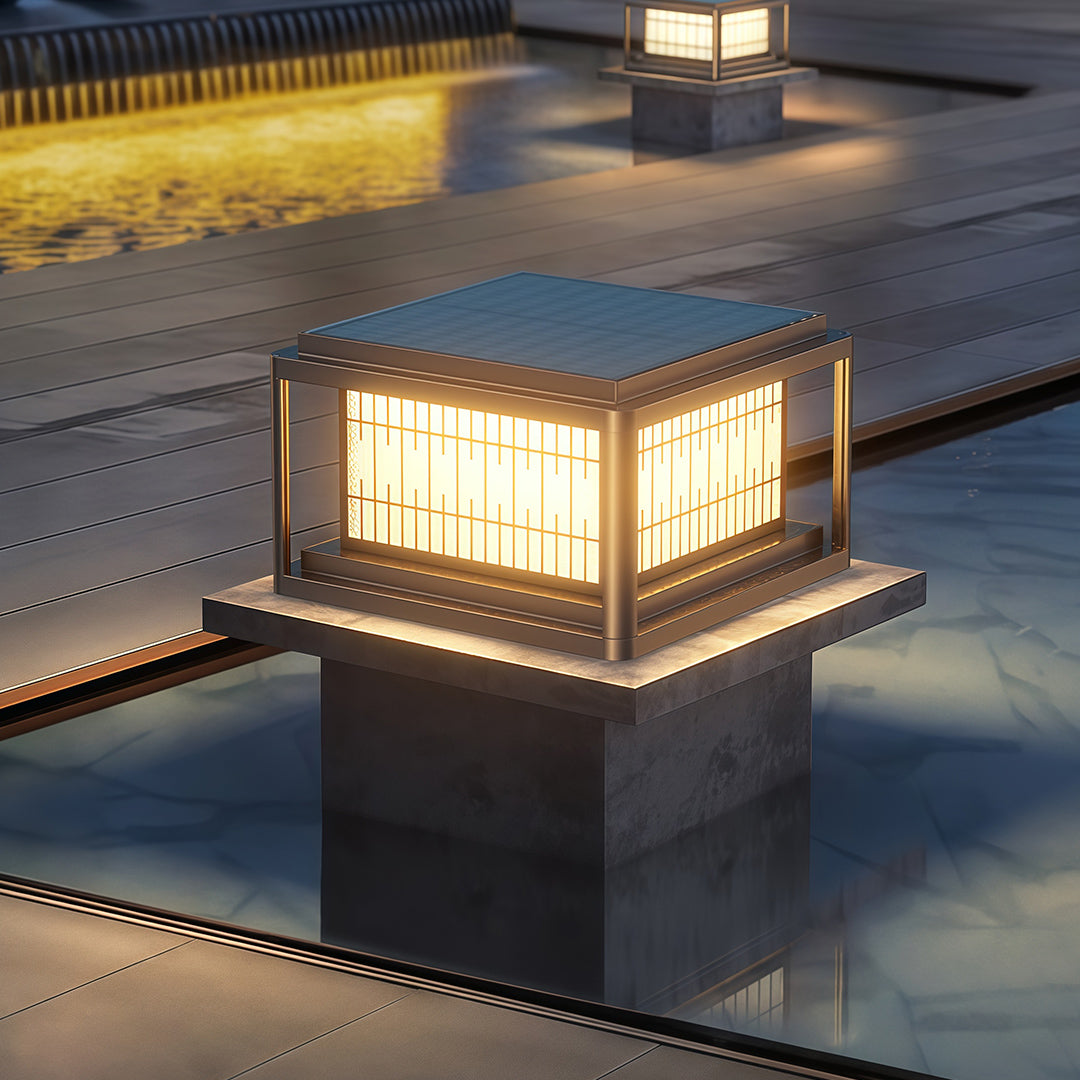 Outdoor pillar LED light creating ambient illumination on concrete platform near pool at evening.
