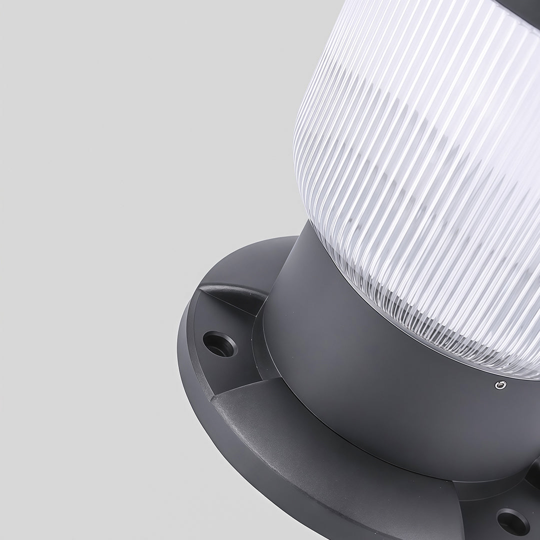 Outdoor pillar light mounted on a decorative pillar, lighting up the yard path at night.