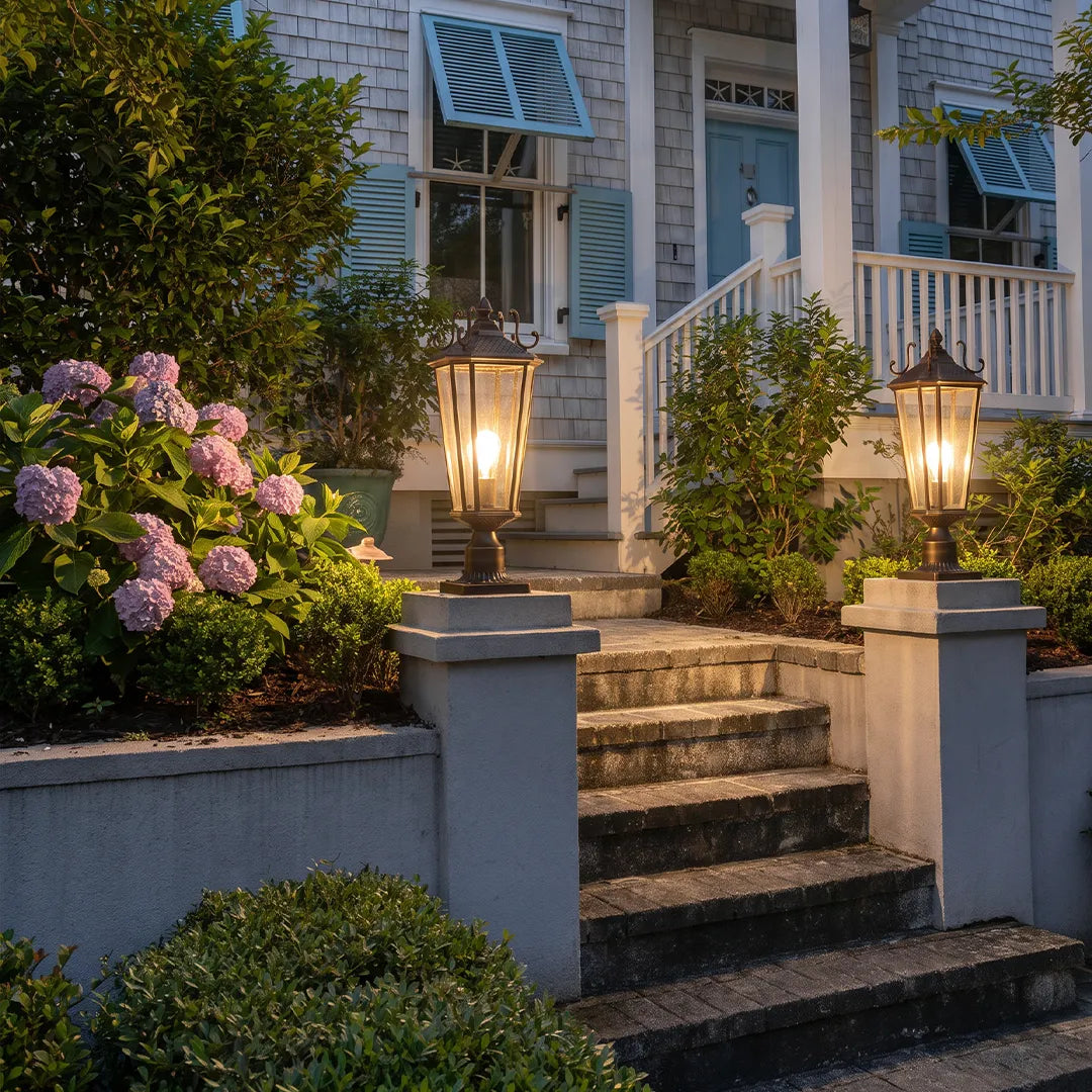 Outdoor pillar light fixtures lining front entry steps with classic lantern styling and warm exterior lighting.