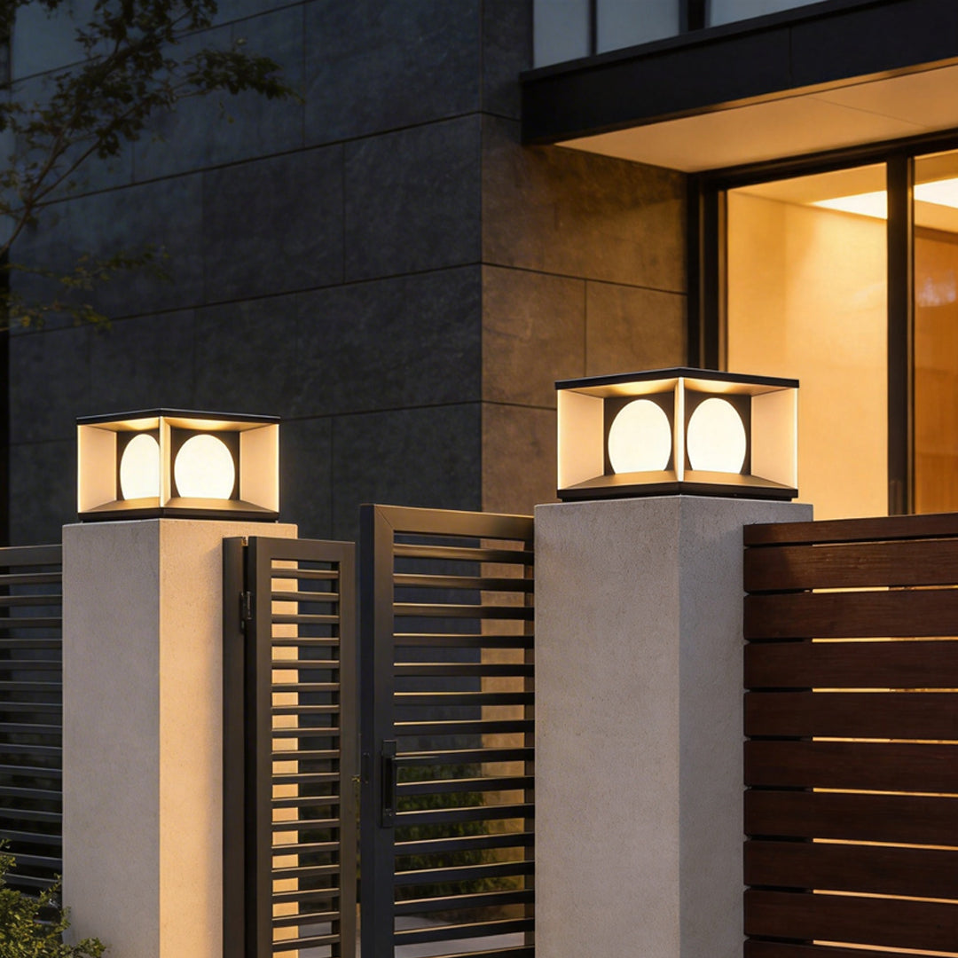 Outdoor pillar light illuminating a modern garden pathway with warm ambient glow.