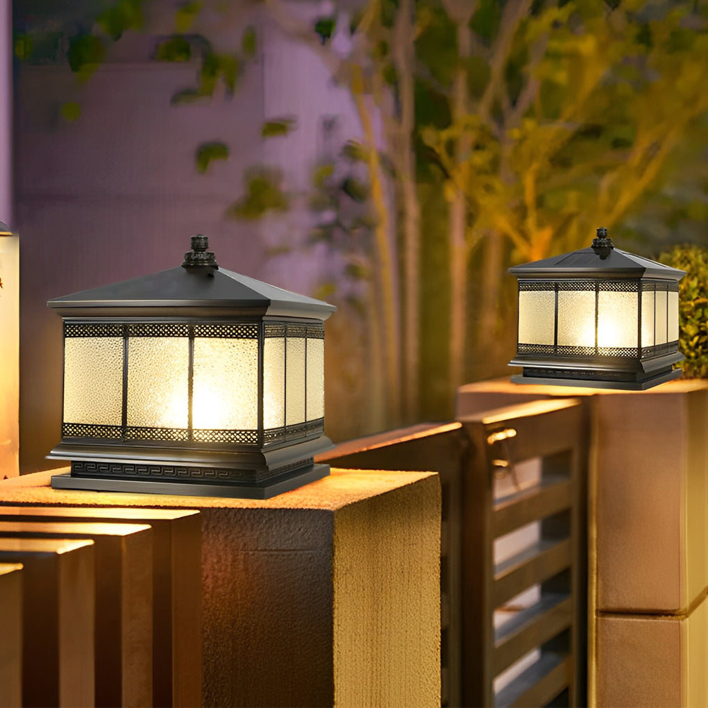 Outdoor pillar light set on a railing post, creating soft illumination for a patio entrance.