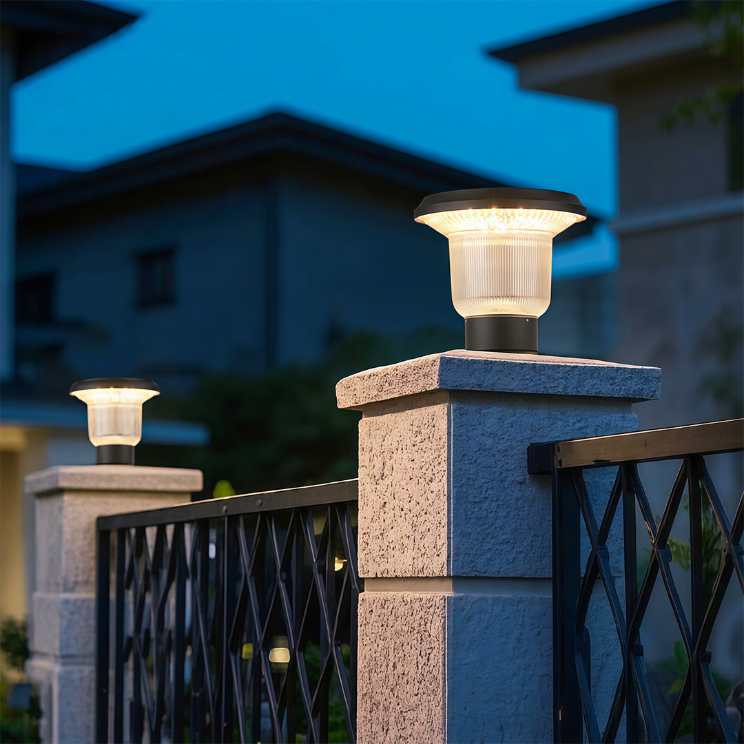 Outdoor pillar light placed on a stone column, offering ambient lighting for a serene garden space.