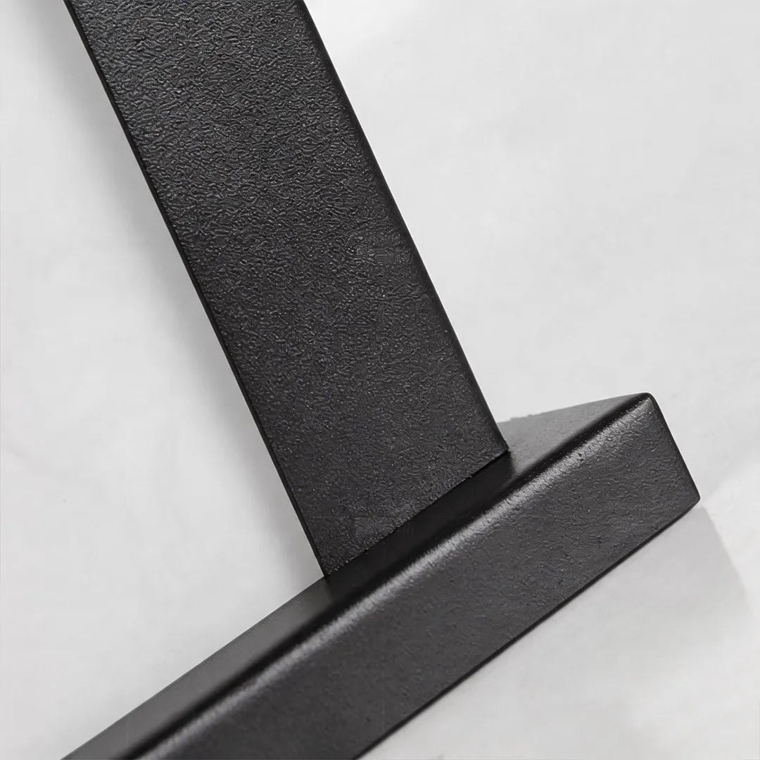 Outdoor pillar light with textured black metal frame and mounting detail