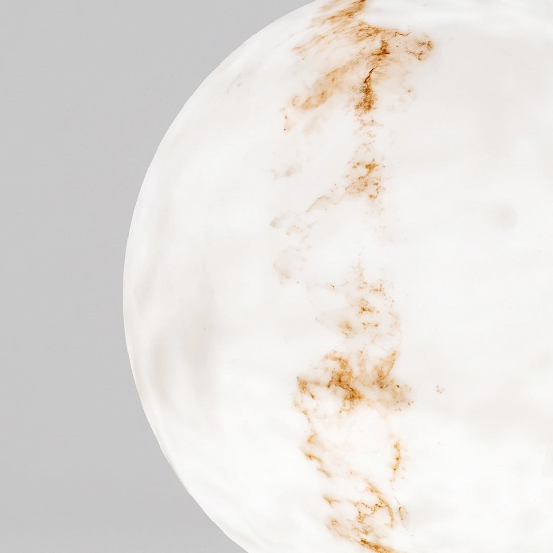 Close-up of the white marble-look surface and natural veining detail on outdoor pillar lights.